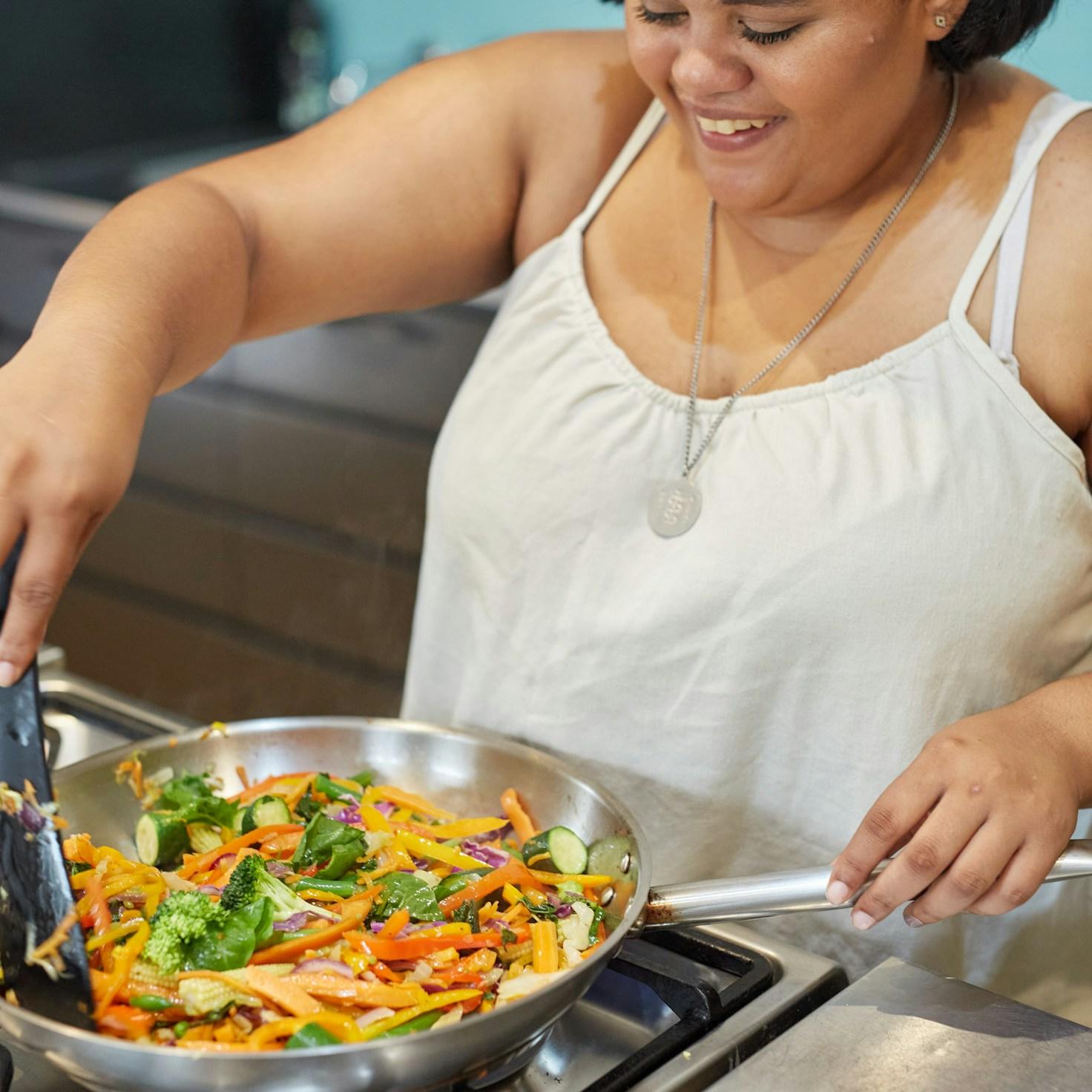 Community members collaborating in a modern kitchen space, sharing recipes and cooking techniques